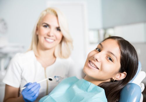 mid-adult-dentist-with-patient-dental-clinic